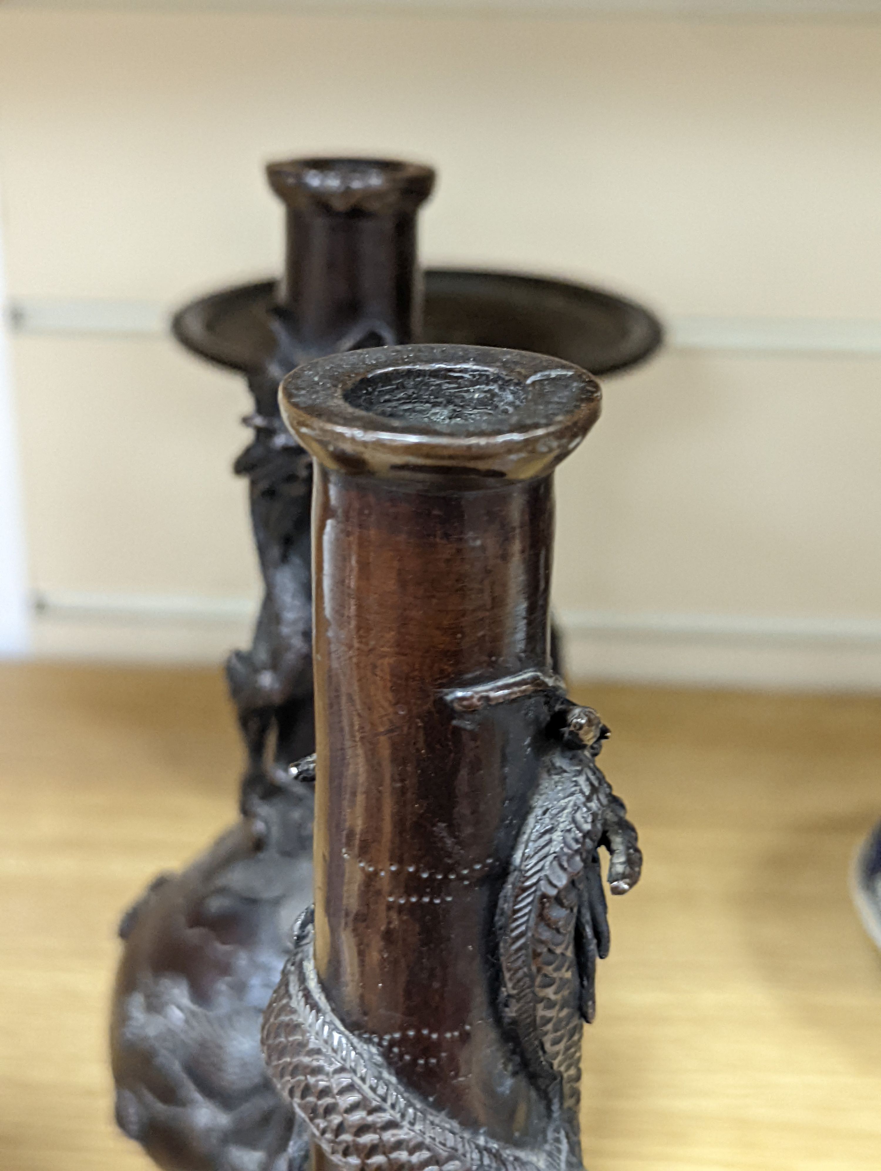 A pair of Japanese Meiji period bronze ‘dragon’ bottle vases and another, 21cm